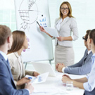 Confident businesswoman explaining something to colleagues at meeting